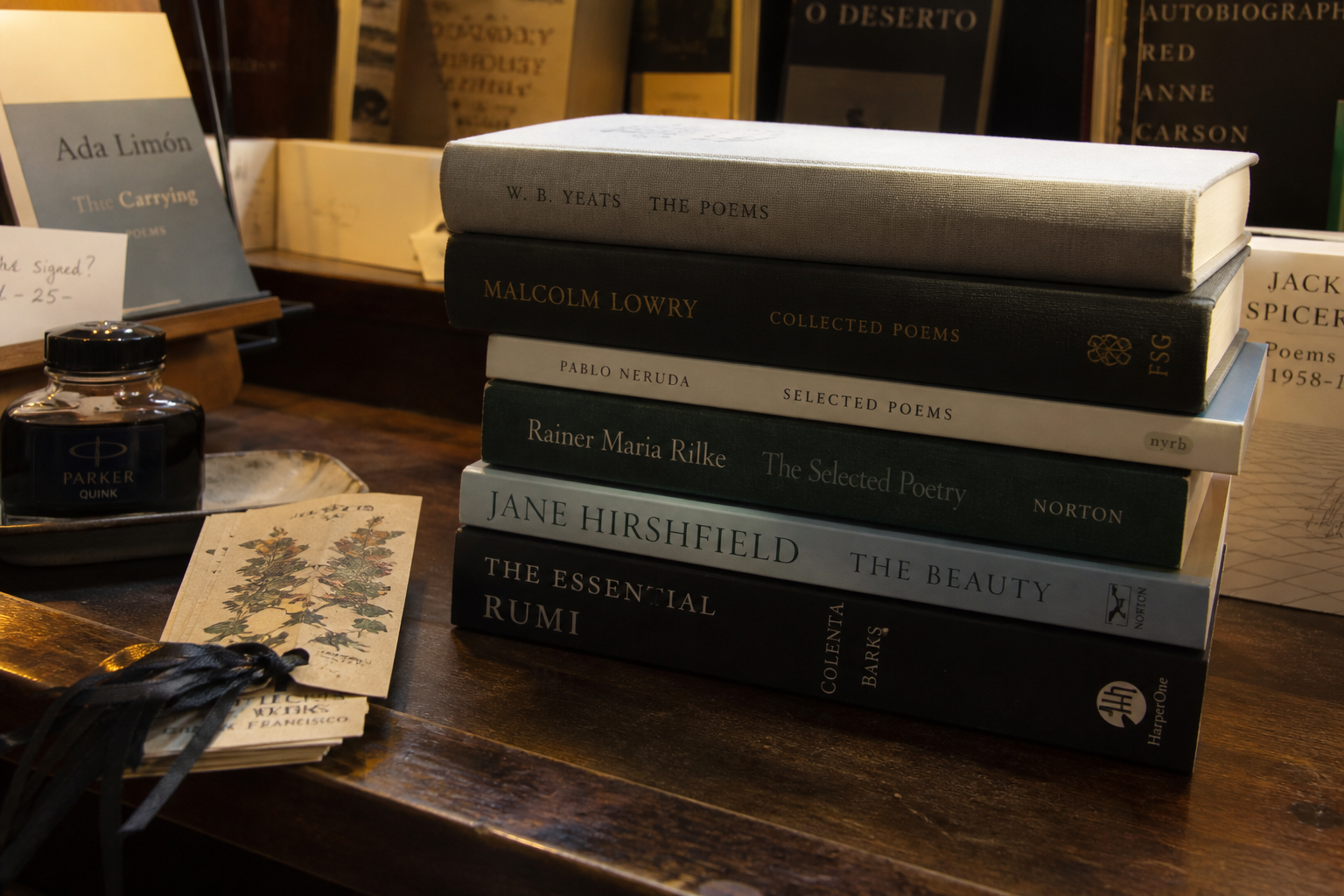 Stack of poetry volumes beside ink and bookmarks